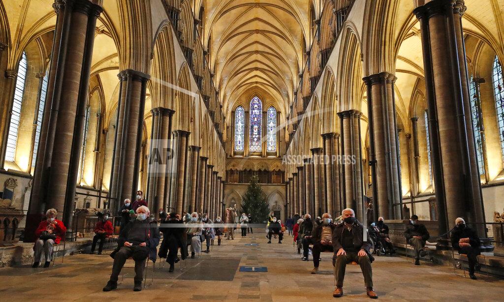 Frank Augstein People sit and relax after receiving their Pfizer-BioNTech vaccination at Salisbury Cathedral in Salisbury, England, Wednesday, Jan. 20, 2021. Salisbury Cathedral opened its doors for the second time as a venue for the Sarum South Primary Care Network COVID-19 Local Vaccination Service. (AP Photo/Frank Augstein)