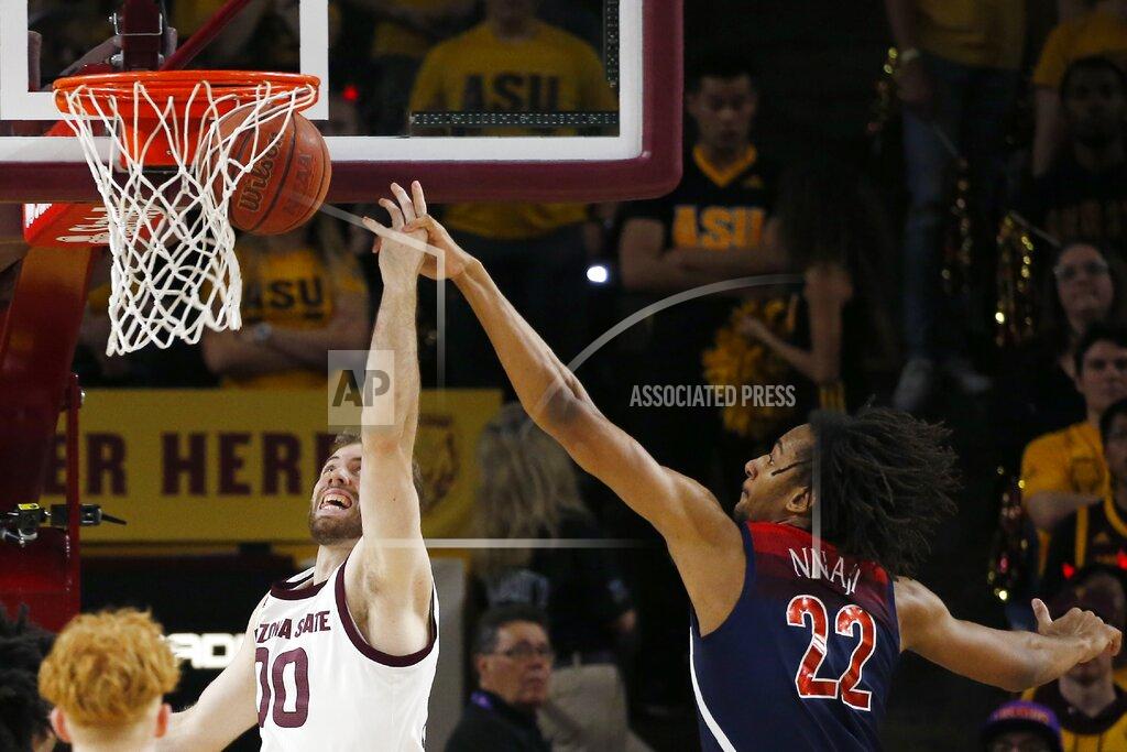 Ross D. Franklin Arizona State forward Mickey Mitchell (00) has his shot blocked by Arizona forward Zeke Nnaji (22) during the first half of an NCAA college basketball game Saturday, Jan. 25, 2020, in Tempe, Ariz. (AP Photo/Ross D. Franklin)