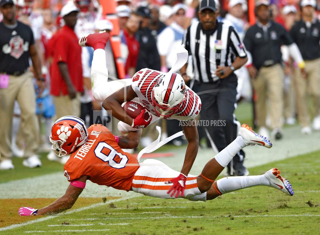 Richard Shiro North Carolina State's C.J. Riley(19) is upended by Clemson's A.J. Terrell during the second half of an NCAA college football game, Saturday, Oct. 20, 2018, in Clemson, S.C. (AP Photo/Richard Shiro)
