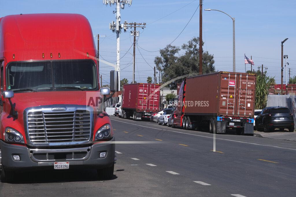 Ringo H.W. Chiu Parked cargo container trucks are seen in a street, Wednesday, Oct. 20, 2021 in Wilmington, Calif. California Gov. Gavin Newsom on Wednesday issued an order that aims to ease bottlenecks at the ports of Los Angeles and Long Beach that have spilled over into neighborhoods where cargo trucks are clogging residential streets. (AP Photo/Ringo H.W. Chiu)