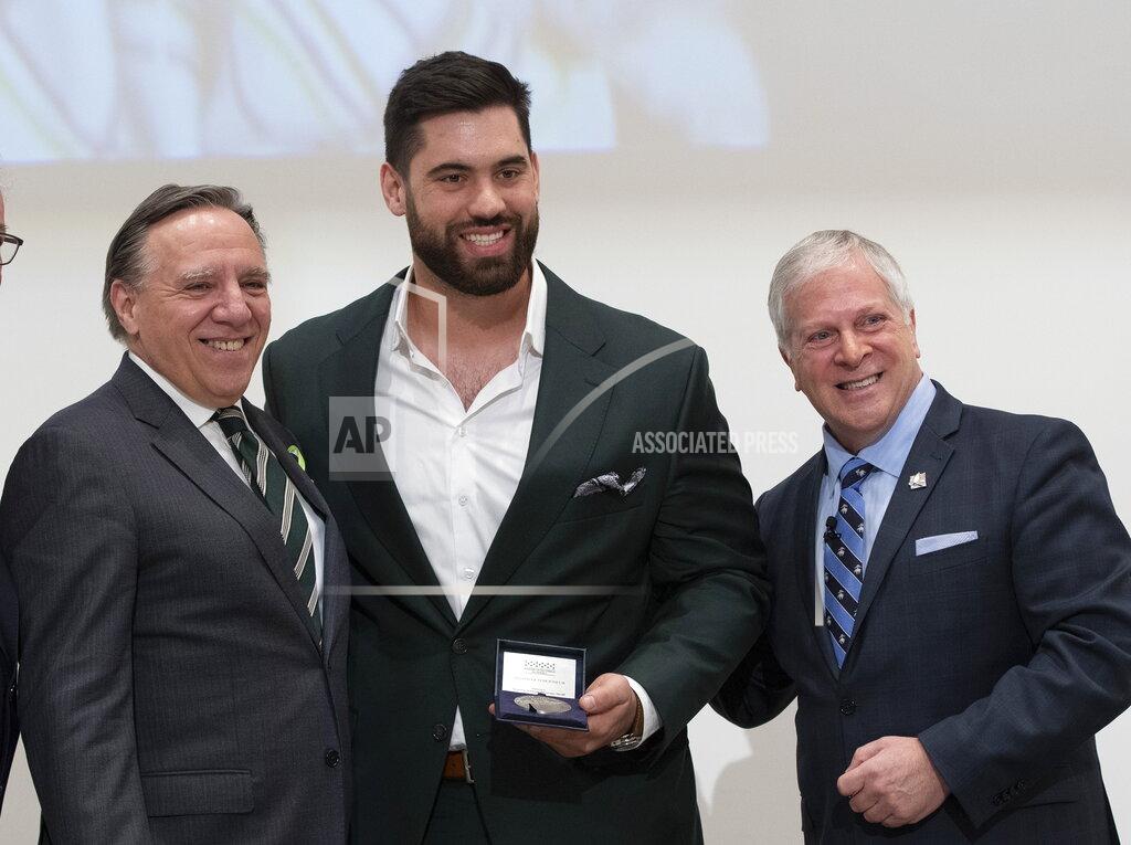 Jacques Boissinot Kansas City Chiefs' Laurent Duvernay-Tardif, center, receives the National Assembly of Quebec Medal of Honour from Speaker Francois Paradis, right, while Quebec Premier Francois Legault, left, looks on, Tuesday, Feb. 18, 2020 at the legislature in Quebec City, Quebec. (Jacques Boissinot/The Canadian Press via AP)