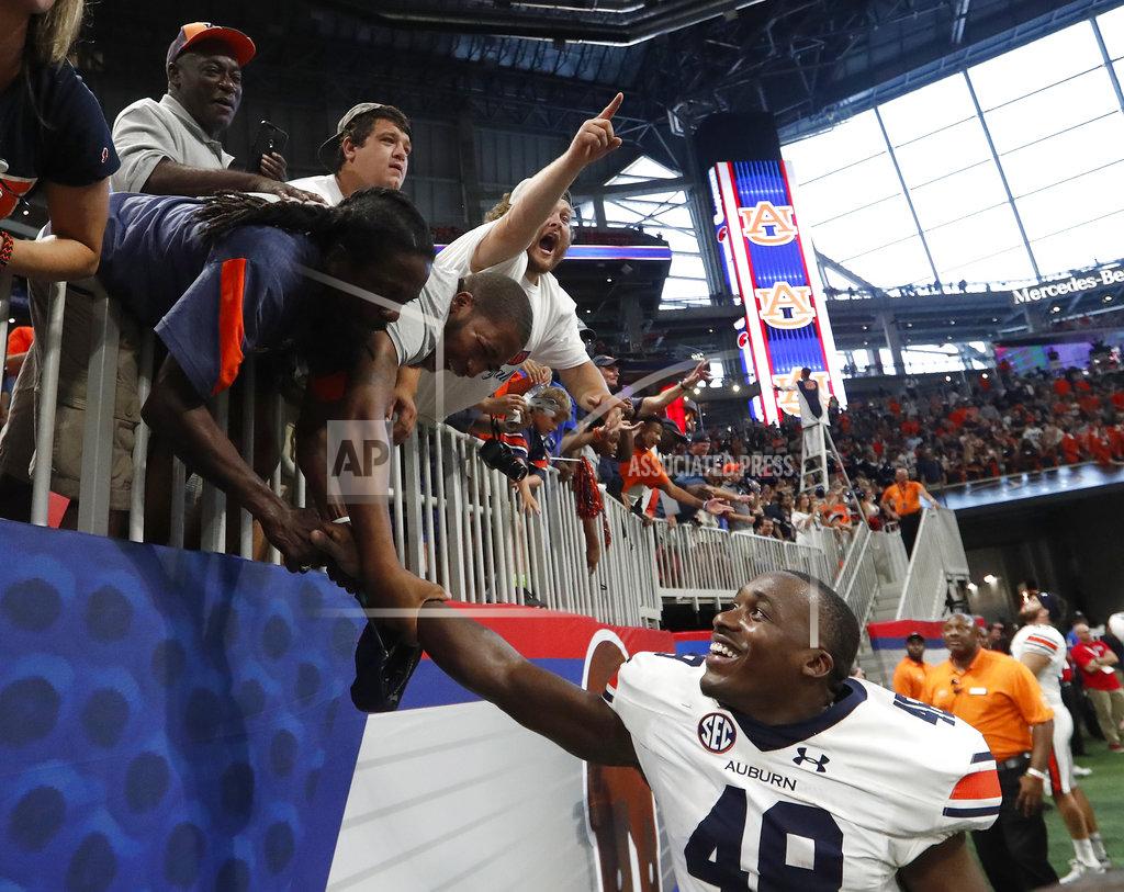 John Bazemore FILE - In this Saturday, Sept. 1, 2018, file photo, Auburn linebacker Montavious Atkinson (48) celebrates with he fans after their 21-16 win over Washington in an NCAA college football game in Atlanta. Proof of the SEC’s strength has come in No. 9 Auburn’s win over No. 10 Washington to open the season and No. 6 Louisiana State’s wins over No. 21 Miami and Auburn. (AP Photo/John Bazemore, File)