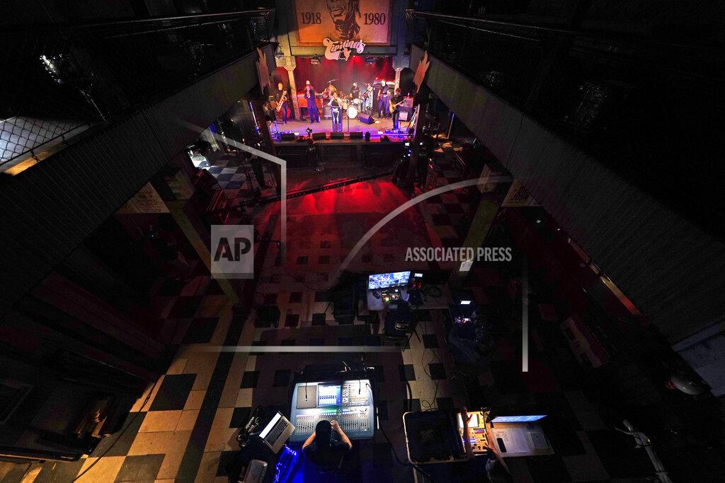 Gerald Herbert FILE - In this Oct. 26, 2020, file photo, production engineers record the band Galactic for a video stream concert, inside an empty Tipitina's music club in New Orleans. Three New Orleans music venues are going to require proof of coronavirus vaccination or a negative test to get in the club. The clubs _ Tipitina's, the Maple Leaf Bar and d.b.a. _ made the announcement late Wednesday, July 28, 2021, in a news release. The new rule will go into effect for performances at the venues this Friday. (AP Photo/Gerald Herbert)