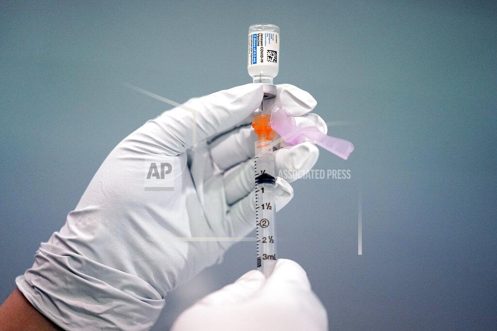 Matt Rourke FILE - In this March 26, 2021, file photo a member of the Philadelphia Fire Department prepares a dose of the Johnson & Johnson COVID-19 vaccine at a vaccination site setup in Philadelphia. The vaccination drive is lagging far behind in many Amish communities across the U.S. following a wave of virus outbreaks that swept through their churches and homes during the past year. (AP Photo/Matt Rourke, File)