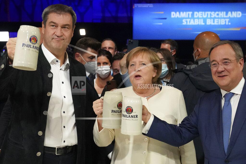 Matthias Schrader German chancellor Angela Merkel, Bavarian State Governor Markus Soeder, left, and Christian Democrats candidate Armin Laschet attend a state election campaign in Munich, Germany, Friday, Sept. 24, 2021 two days before the General election on Sunday, Sept. 26, 2021. (AP Photo/Matthias Schrader)