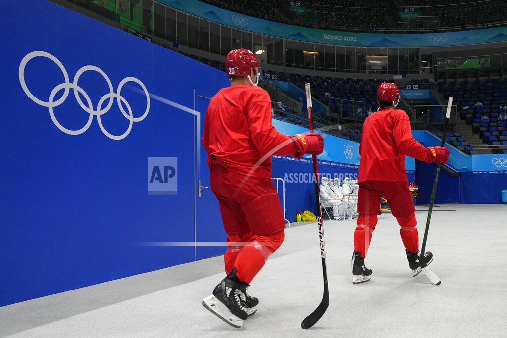 Petr David Josek China players enter the arena to attend a men's hockey practice session at the 2022 Winter Olympics, Sunday, Jan. 30, 2022, in Beijing. (AP Photo/Petr David Josek)
