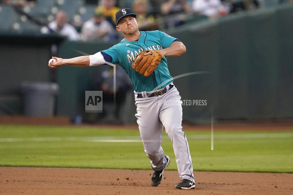 Jeff Chiu Seattle Mariners third baseman Kyle Seager throws out Oakland Athletics' Josh Harrison at first base during the first inning of a baseball game in Oakland, Calif., Monday, Sept. 20, 2021. (AP Photo/Jeff Chiu)