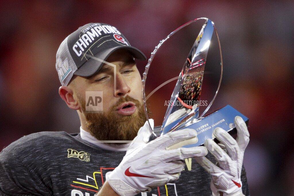 Charlie Riedel Kansas City Chiefs' Travis Kelce holds the Lamar Hunt Trophy after the NFL AFC Championship football game against the Tennessee Titans Sunday, Jan. 19, 2020, in Kansas City, MO. The Chiefs won 35-24 to advance to Super Bowl 54. (AP Photo/Charlie Riedel)