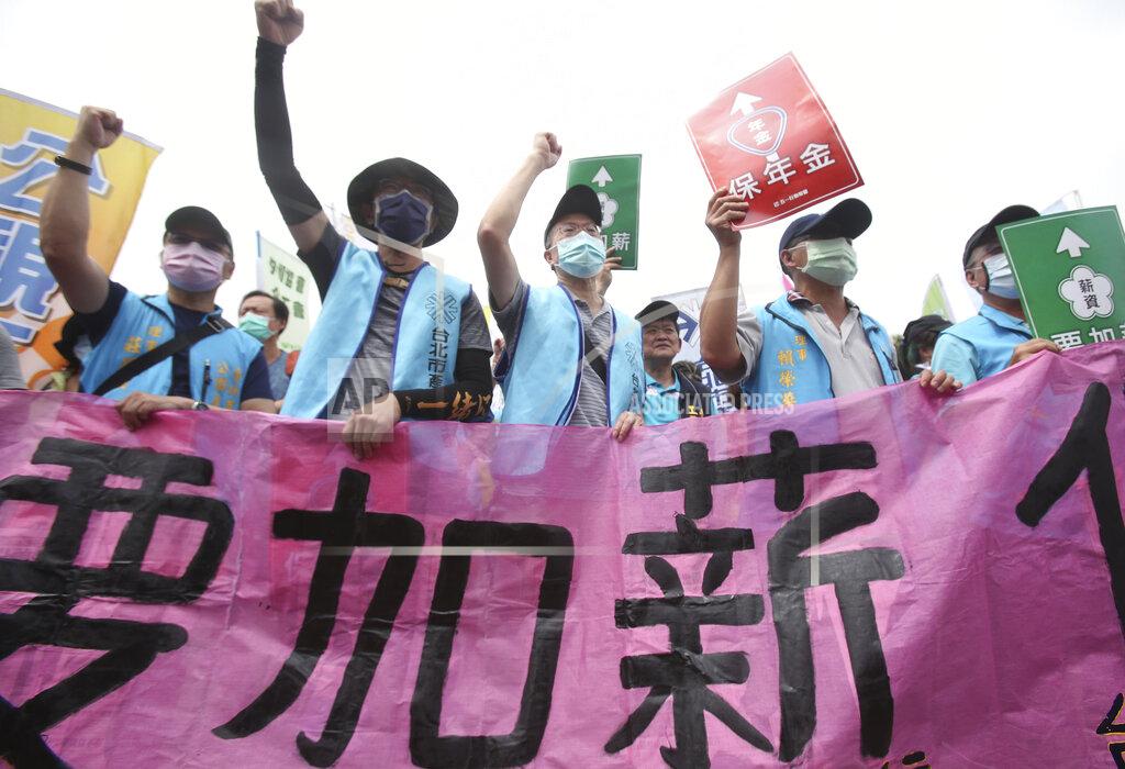 Chiang Ying-Ying Taiwanese workers shout and hold slogans reading "Increase Salary, Secure Annuity" during a May Day rally in Taipei, Taiwan, Saturday, May 1, 2021. Thousands of protesters from different labor groups protest on the street to ask for increasing salary and securing annuity. (AP Photo/Chiang Ying-ying)
