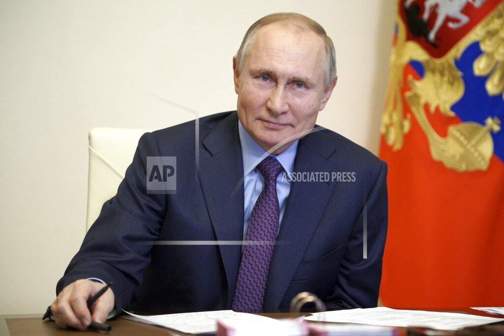 Russian President Vladimir Putin listens during a meeting with government officials via video conference at the Novo-Ogaryovo residence outside Moscow, Russia, Monday, March 22, 2021. Putin said he will get vaccinated against the coronavirus on Tuesday, months after widespread vaccination has started in Russia. (Alexei Druzhinin, Sputnik, Kremlin Pool Photo via AP)