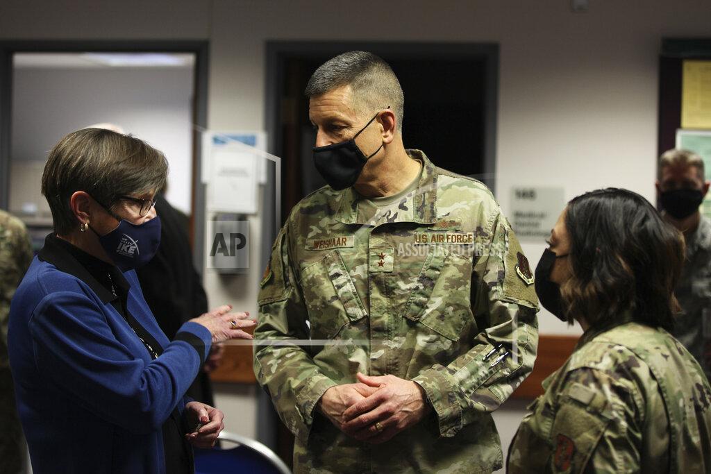 John Hanna Kansas Gov. Laura Kelly, left, confers with Maj. Gen. David Weishaar, center, and Capt. Ana Tavares, right, during a COVID-19 vaccine clinic for Kansas National Guard personnel, Friday, Feb. 5, 2021, at Air National Guard's base south of Topeka, Kan. Weishaar is the Kansas National Guard's commanding officer and the state's top emergency management official. (AP Photo/John Hanna)