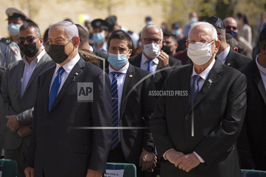 Maya Alleruzzo Israeli Prime Minister Benjamin Netanyahu, left, stands next to President Revin Rivlin as they attend a ceremony marking the annual Holocaust Remembrance Day, at Yad Vashem Holocaust Memorial in Jerusalem, Thursday, April 8, 2021. (AP Photo/Maya Alleruzzo, Pool)