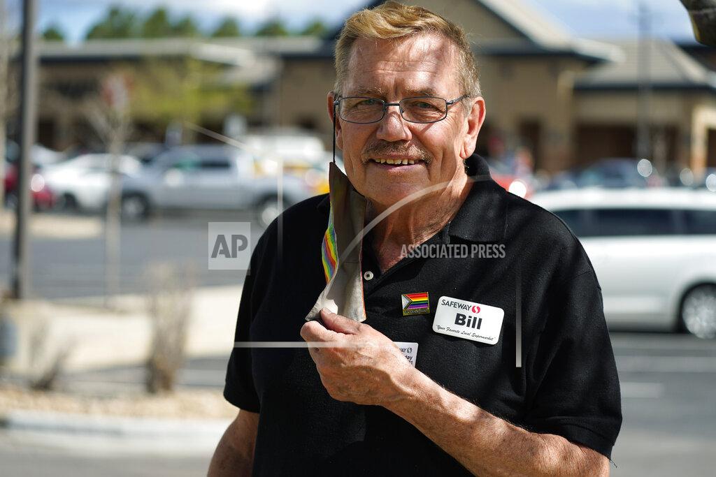 David Zalubowski In this Wednesday, May 19, 2021, photograph, Bill Easton, a checker at a Safeway grocery store, is shown in the shopping center in which the store is located in Aurora, Colo. Easton, like many other workers in retail sales jobs, is fully vaccinated but is concerned about risks posed as retailers change their mask-wearing policies for customers. (AP Photo/David Zalubowski)