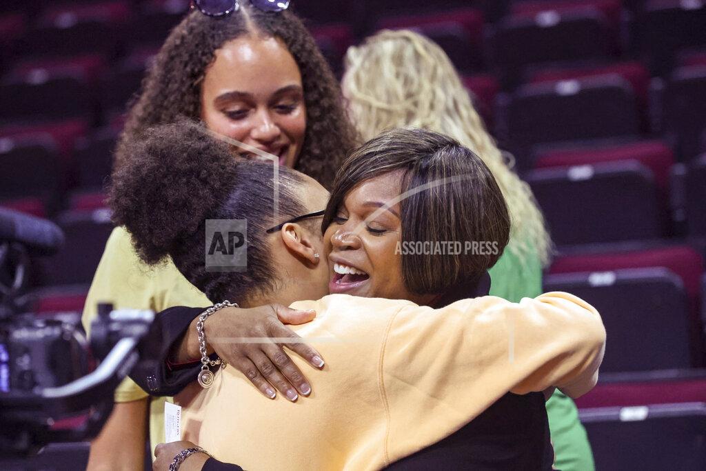 Andrew Mills Coquese Washington, right, is embraced by her former player, Olivia Miles of Notre Dame, during a news conference to introduce Washington as the new women's basketball coach at Rutgers on Tuesday, May 24, 2022 in Piscataway, N.J. Washington was the associate head coach at Notre Dame for two seasons before being hired by Rutgers this week. (Andrew Mills/NJ Advance Media via AP)