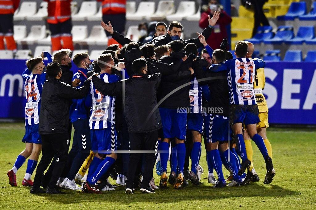 Jose Breton Alcoyano players celebrate after knocking out Real Madrid during a Spanish Copa del Rey round of 32 soccer match between Alcoyano and Real Madrid at the El Collao stadium in Alcoy, Spain, Wednesday Jan. 20, 2021. (AP Photo/Jose Breton)