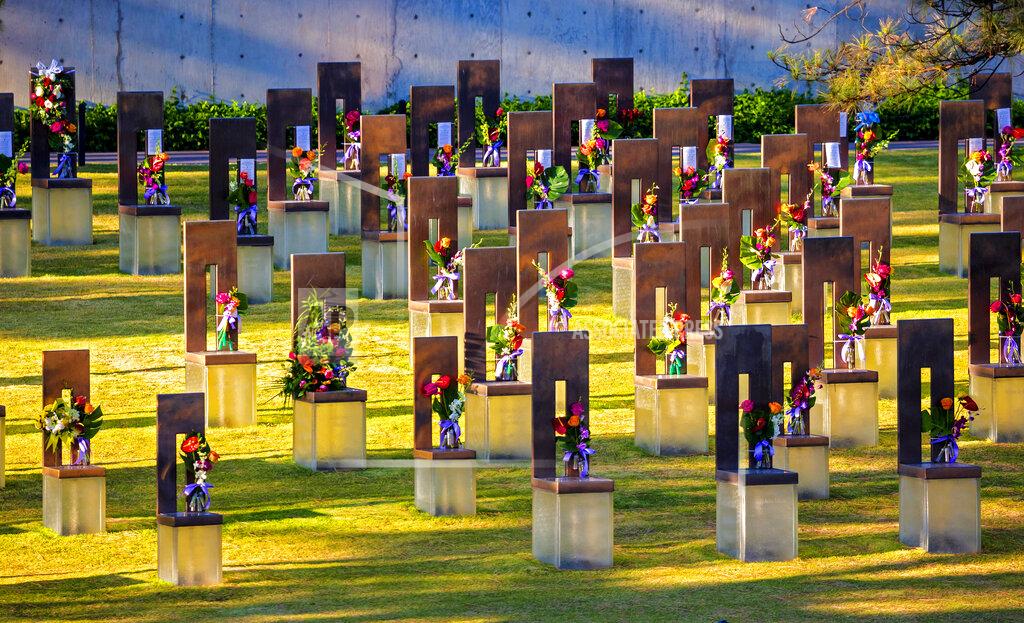 Chris Landsberger Flowers decorate the memorial chairs in the Field of Chairs for the 26th Anniversary Remembrance Ceremony at the Oklahoma City National Memorial and Museum in Oklahoma City, Okla on Monday, April 19, 2021. (Chris Landsberger/The Oklahoman via AP)