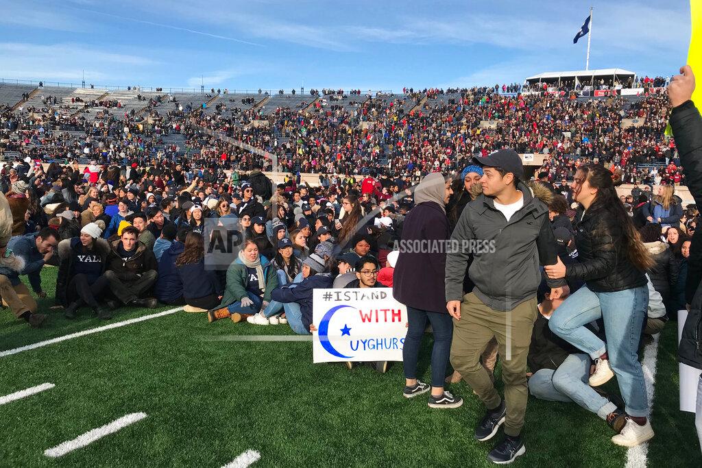 Jimmy Golen Demonstrators stage a protest on the field at the Yale Bowl disrupting the start of the second half of an NCAA college football game between Harvard and Yale, Saturday, Nov. 23, 2019, in in New Haven, Conn. (AP Photo/Jimmy Golen)