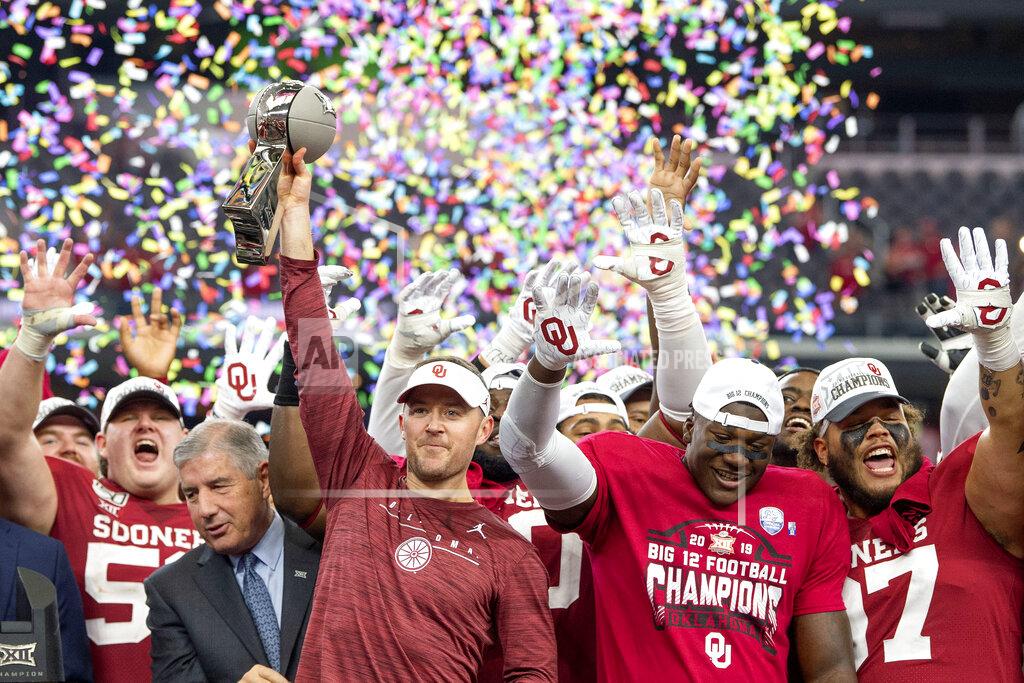 FILE - In this Dec. 7, 2019, file photo, Oklahoma head coach Lincoln Riley hosts the Big 12 Conference championship trophy after defeating Baylor 30-23 in overtime in an NCAA college football game in Arlington, Texas. Riley will earn an average of more than $7.5 million a year under a contract extension through the 2025 season. The university's board of regents approved the two-year extension Tuesday, July 28, 2020. (AP Photo/Jeffrey McWhorter, File)