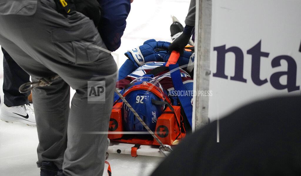 David Zalubowski Colorado Avalanche defenseman Jacob MacDonald is pulled off the ice on a backboard after being injured in the second period of an NHL hockey game against the Florida Panthers Sunday, Dec. 12, 2021, in Denver. (AP Photo/David Zalubowski)