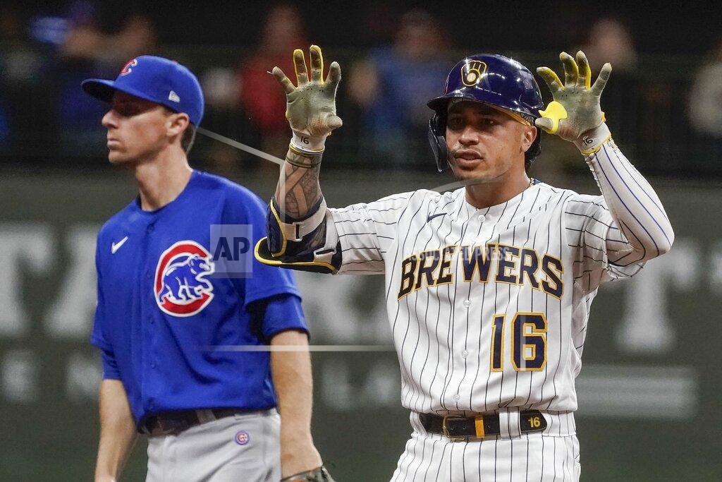 Morry Gash Milwaukee Brewers' Kolten Wong reacts to his double in front of Chicago Cubs' Matt Duffy during the fourth inning of a baseball game Friday, Sept. 17, 2021, in Milwaukee. (AP Photo/Morry Gash)