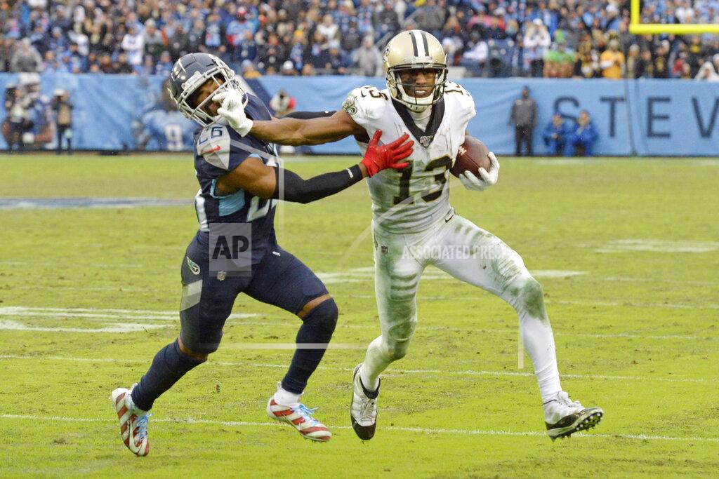Mark Zaleski File-This Dec. 22, 2019, file photo shows New Orleans Saints wide receiver Michael Thomas (13) pushing past Tennessee Titans cornerback Logan Ryan (26) after Thomas makes a reception in the second half of an NFL football game in Nashville, Tenn. The catch gave Thomas the single-season pass reception record. Regardless of the record stream of receptions by Thomas, the sacks by Chandler Jones and lengthy field goals by nearly every placekicker, the headlines regularly were about referees and field judges. (AP Photo/Mark Zaleski,File)