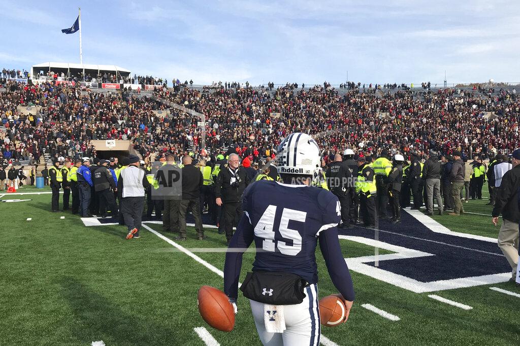 Jimmy Golen Yale punter Jack Bosman watches as demonstrators stage a protest on the field at the Yale Bowl disrupting the start of the second half of an NCAA college football game between Harvard and Yale, Saturday, Nov. 23, 2019, in in New Haven, Conn. (AP Photo/Jimmy Golen)