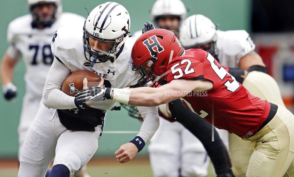Charles Krupa Yale quarterback Griffin O'Connor, left, tries to elude Harvard linebacker Cameron Kline (52) while scrambling for a gain during the first half of an NCAA college football game at Fenway Park in Boston, Saturday, Nov. 17, 2018. (AP Photo/Charles Krupa)