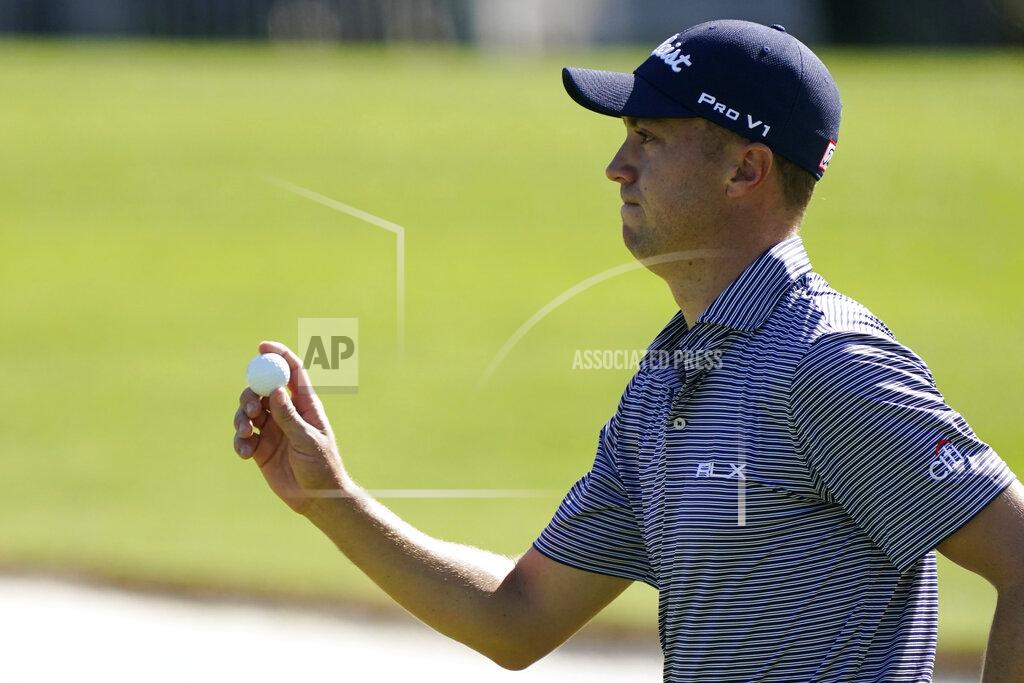 Charlie Riedel Justin Thomas holds up his ball after a birdie putt on the 18th hole during the second round of the Masters golf tournament Friday, Nov. 13, 2020, in Augusta, Ga. (AP Photo/Charlie Riedel)