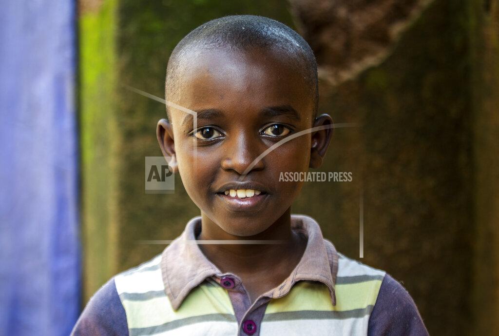 Uncredited Tresor Ndizihiwe, 12, poses for a photo at his home in Kigali, Rwanda on Tuesday, April 21, 2020. No school. No playing with friends. Soldiers everywhere. That’s life during the coronavirus pandemic for Tresor Ndizihiwe, a 12-year-old boy who lives in Rwanda, one of seven brothers and sisters. (AP Photo)