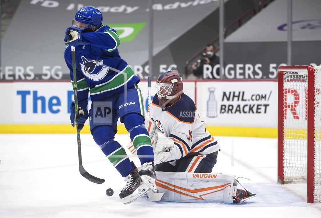 Darryl Dyck Edmonton Oilers goalie Mikko Koskinen, right, of Finland, makes the save while being screened by Vancouver Canucks' Brock Boeser during the second period of an NHL hockey game, Monday, May 3, 2021, in Vancouver, British Columbia. (Darryl Dyck/The Canadian Press via AP)