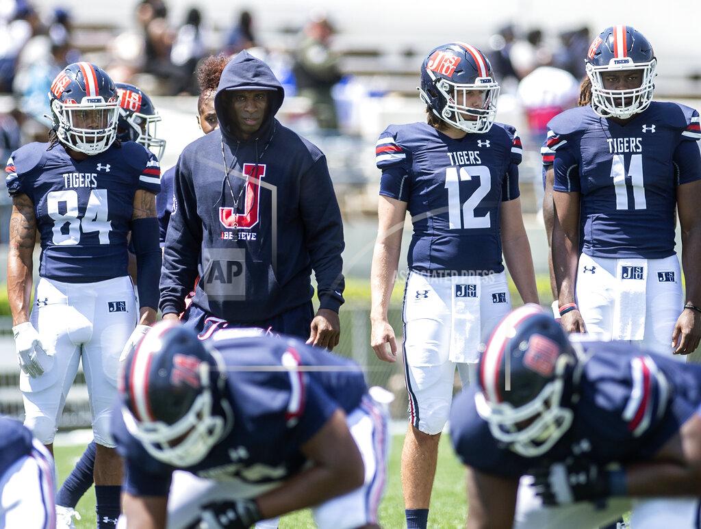 Eric Shelton Jackson State head football coach Deion Sanders, second from left, prepares for JSU's NCAA college football game against Alabama A&M, Saturday, April 10, 2021, at Veterans Memorial Stadium in Jackson, Miss. (Eric Shelton/The Clarion-Ledger via AP)