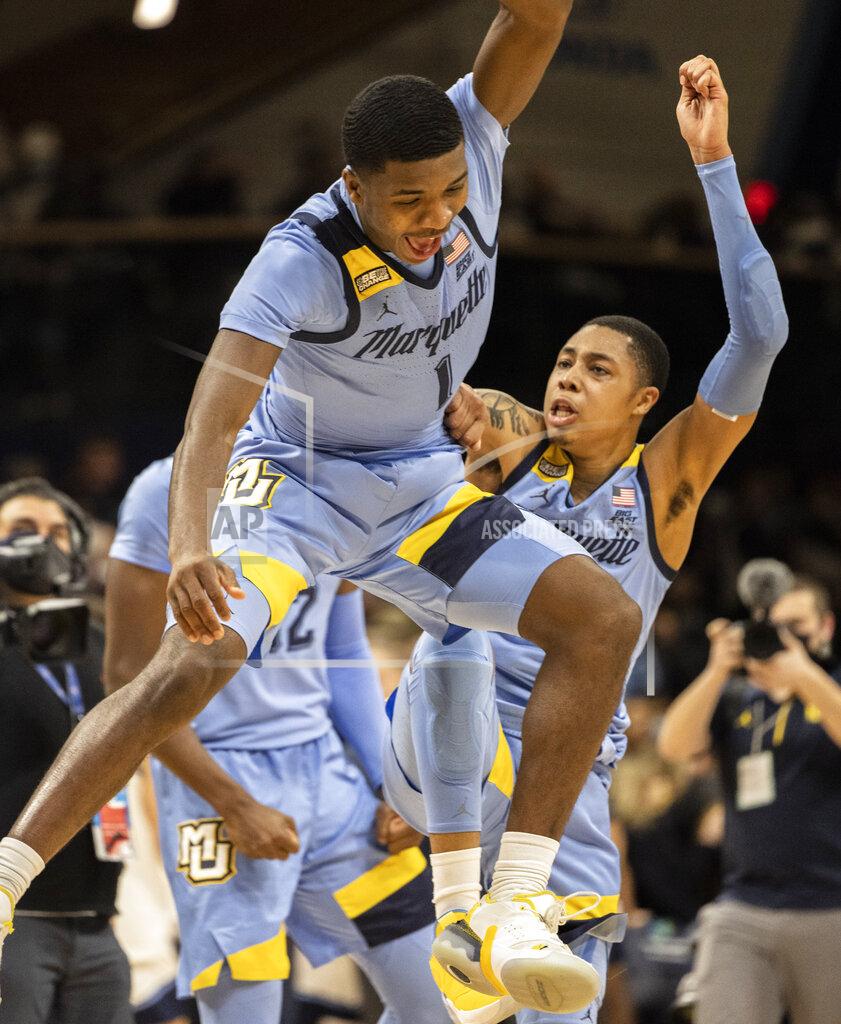 Laurence Kesterson Marquette guard Kam Jones (1) celebrates with forward Olivier-Maxence Prosper (12) and guard Greg Elliott (5) after their team defeated Villanova in an NCAA college basketball game, Wednesday, Jan. 19, 2022, in Villanova, Pa. (AP Photo/Laurence Kesterson)