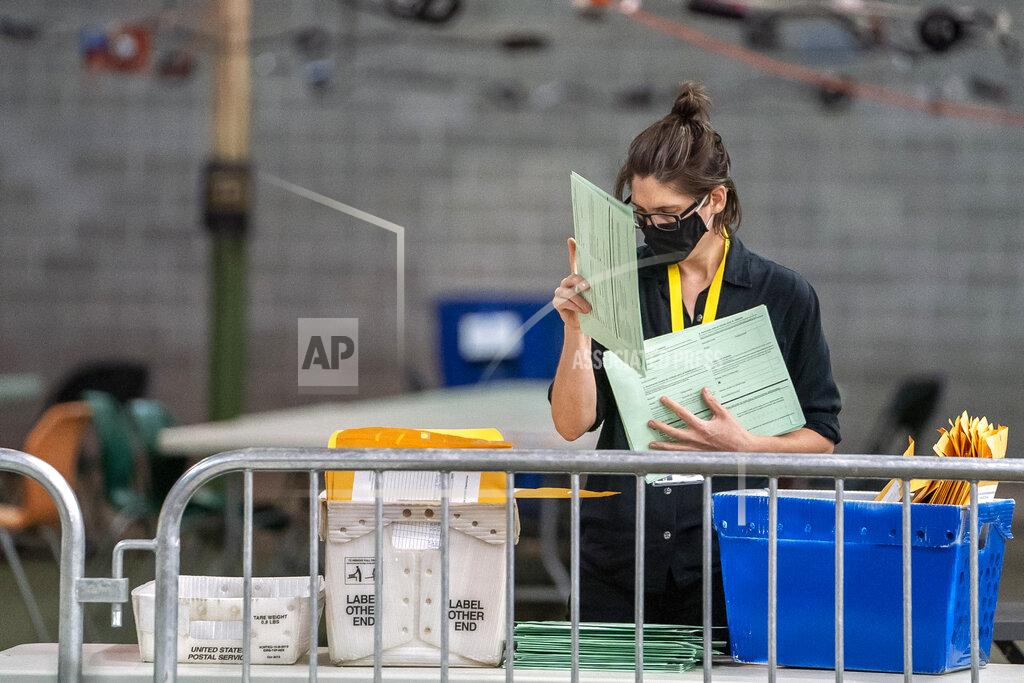 Alexandra Wimley An Allegheny County elections worker opens and begins to process provisional ballots that were not challenged by campaign representatives, Monday, May 23, 2022, on the North Side neighborhood of Pittsburgh. (Alexandra Wimley/Pittsburgh Post-Gazette via AP)