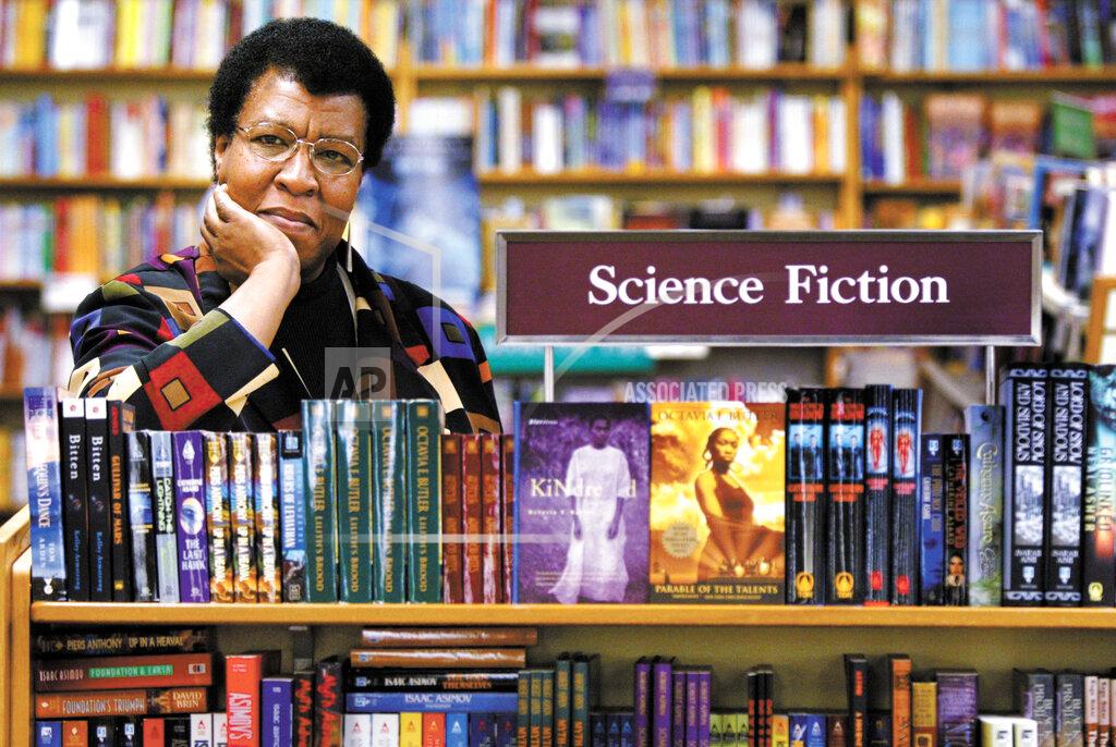 Joshua Trujillo FILE - In this Feb. 4, 2004 file photo, author Octavia Butler poses near some of her novels at University Book Store in Seattle, Wash. Butler, considered the first black woman to gain national prominence as a science fiction writer, died Feb. 24, 2006, at age 58. Fourteen years after her death, Butler has never seemed more relevant. The rare black science fiction writer in her lifetime, she is now praised for anticipating many of the major issues of the day, from pandemics to the election of Donald Trump. (Joshua Trujillo/seattlepi.com via AP, File)