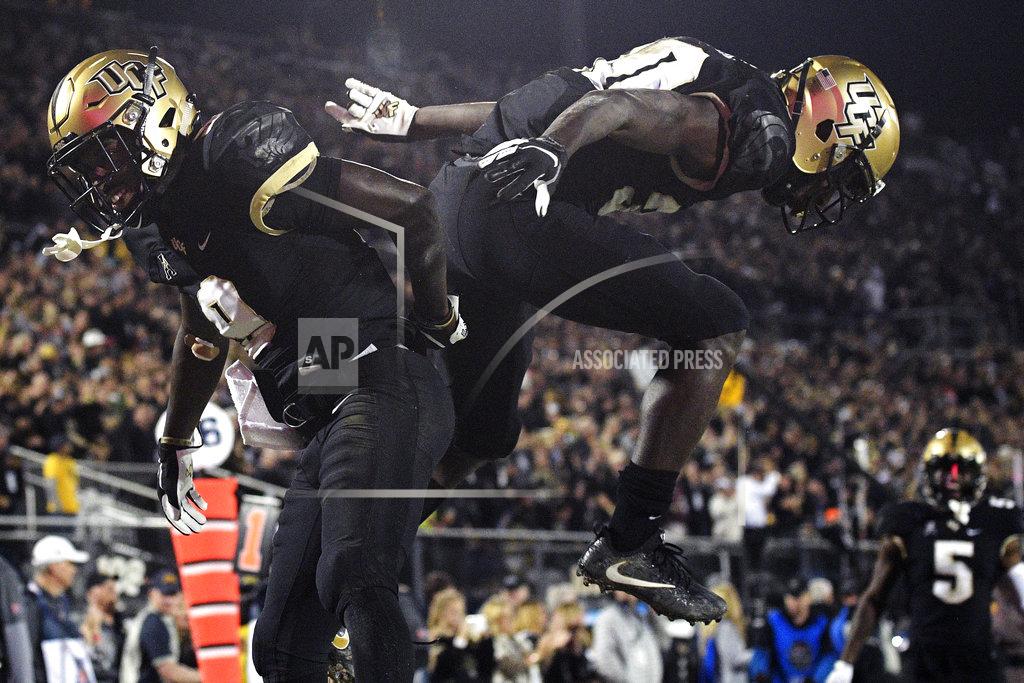 Phelan M. Ebenhack Central Florida running back Greg McCrae (30) celebrates with running back Adrian Killins Jr. (9) after McCrae rushed for a 9-yard touchdown during the second half of an NCAA college football game against Cincinnati Saturday, Nov. 17, 2018, in Orlando, Fla. Central Florida won, 38-13. (AP Photo/Phelan M. Ebenhack)