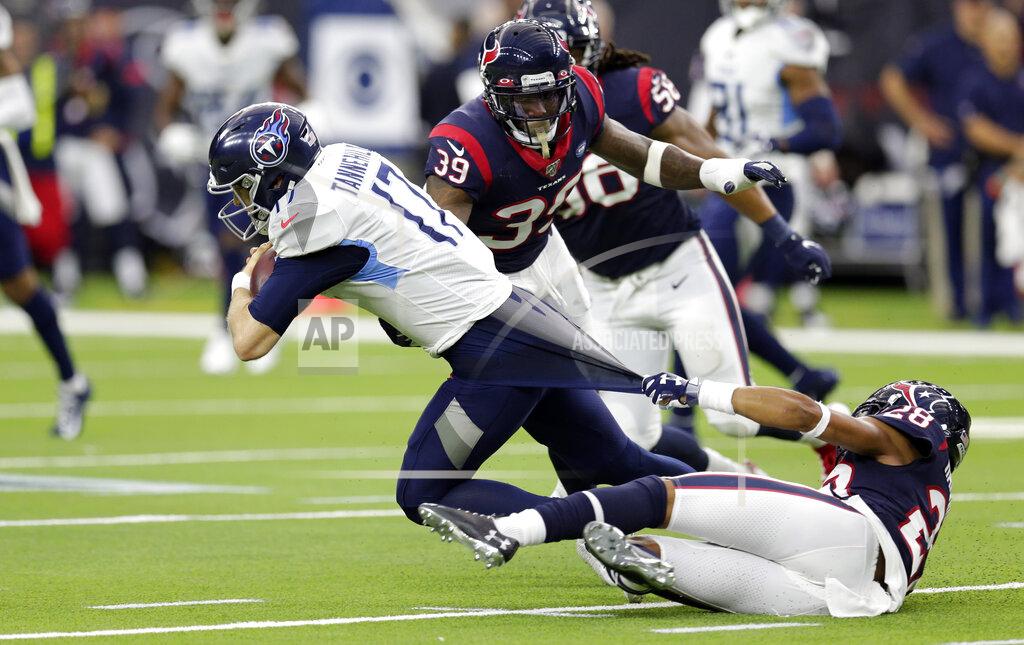 Michael Wyke Houston Texans cornerback Vernon III Hargreaves (28) grabs the shirt of Tennessee Titans quarterback Ryan Tannehill (17) as he tries to tackle him during the first half of an NFL football game Sunday, Dec. 29, 2019, in Houston. (AP Photo/Michael Wyke)