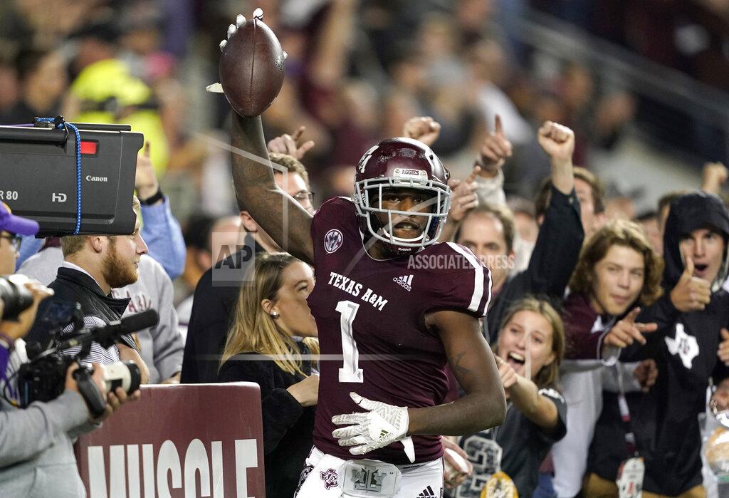 David J. Phillip FILE - In this Nov. 24, 2018, file photo, Texas A&M wide receiver Quartney Davis (1) celebrates after catching a touchdown pass during the seventh overtime of an NCAA college football game against LSU, in College Station, Texas. The NCAA Football Rules Committee on Friday, March 12, 2021, recommended a slight change to overtime rules that would require a team to try a two-point conversion after a touchdown when a game reaches the second overtime instead of the third. (AP Photo/David J. Phillip, File)