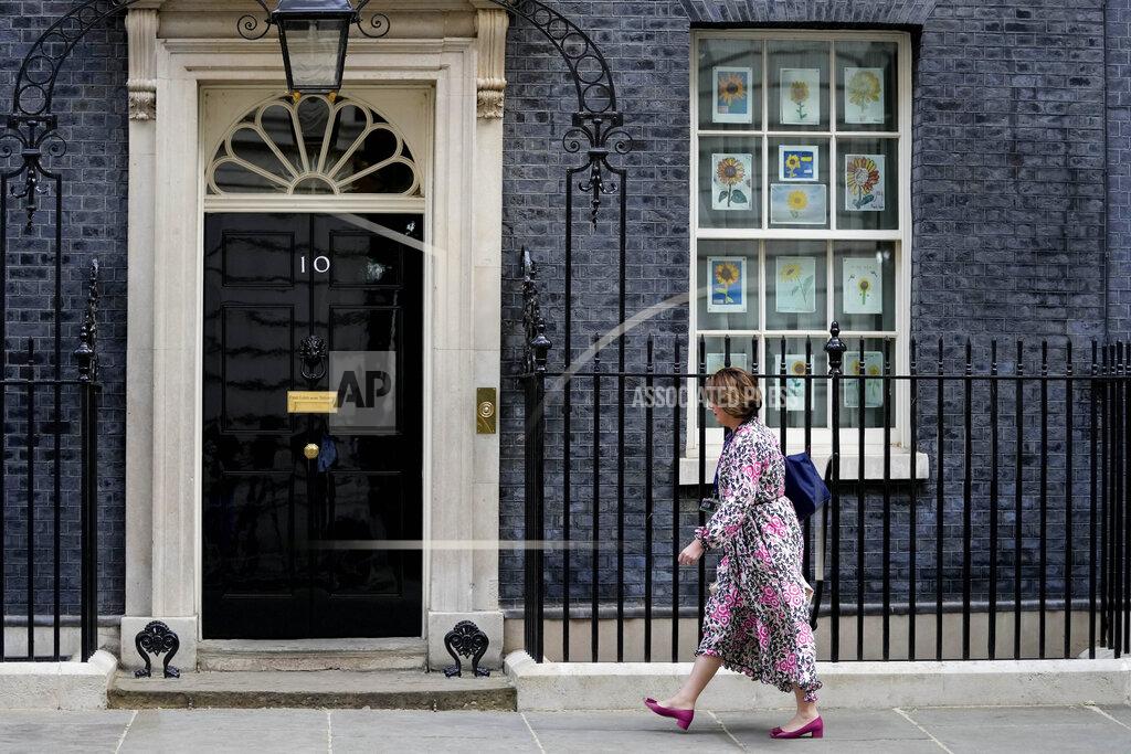Frank Augstein A woman walks towards 10 Downing Street in London, Monday, May 23, 2022. The general public is awaiting the release of Sue Gray's report into COVID lockdown breaches across Whitehall, the so called "Partygate". (AP Photo/Frank Augstein)