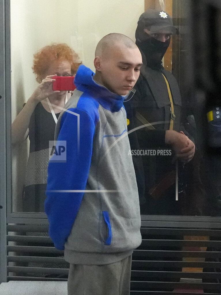 Efrem Lukatsky Russian army Sergeant Vadim Shishimarin, 21, is seen behind a glass during a court hearing in Kyiv, Ukraine, Friday, May 13, 2022. The trial of a Russian soldier accused of killing a Ukrainian civilian opened Friday, the first war crimes trial since Moscow's invasion of its neighbor. (AP Photo/Efrem Lukatsky)