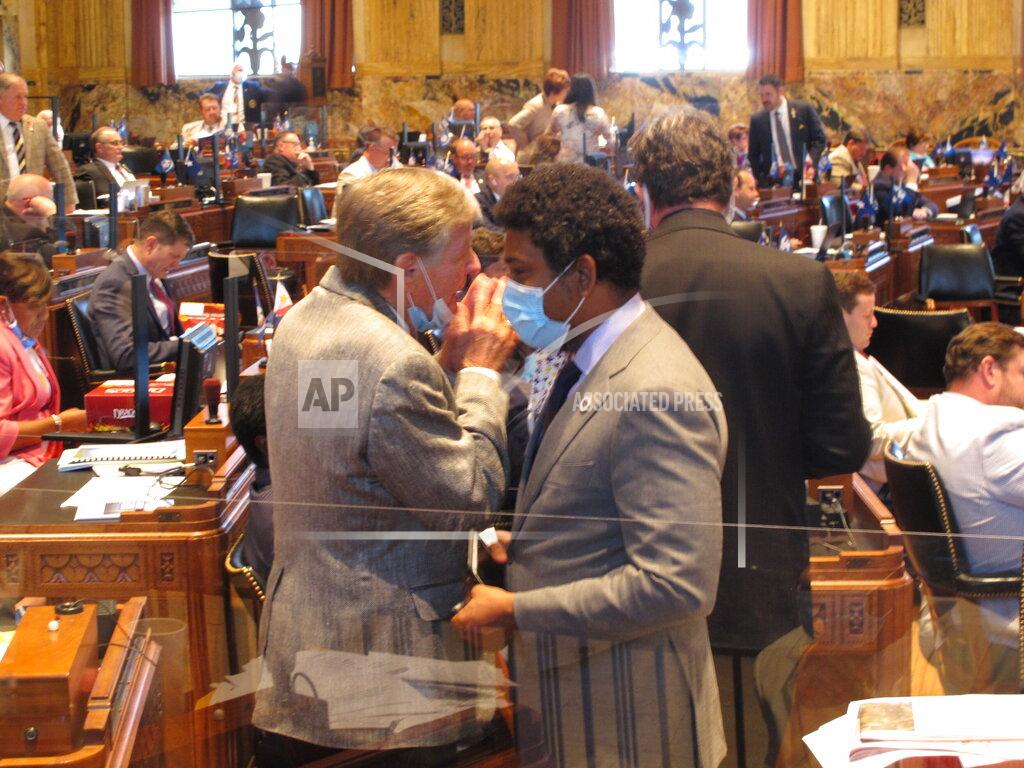 Rep. Francis Thompson, D-Delhi, left, speaks with Rep. Gary Cater, D-New Orleans, on the House floor during a long day of bill debate, on Thursday, May 28, 2020, in Baton Rouge, La. (AP Photo/Melinda Deslatte)