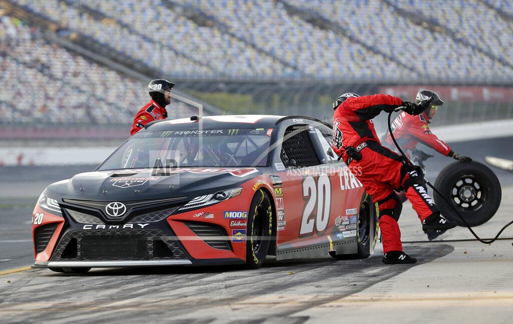 Chuck Burton A crew member jumps out of the way as Erik Jones leaves following a pit stop during qualifying for Saturday's NASCAR All-Star auto race at Charlotte Motor Speedway in Concord, N.C., Friday, May 17, 2019. (AP Photo/Chuck Burton)
