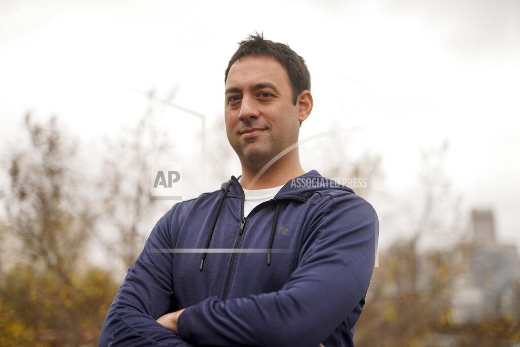Chris Carlson Evan Metaxatos poses for a pictures on Monday, Nov. 30, 2020, in Charlotte, N.C. An analysis shows that few Americans are utilizing contact tracing technology launched in a host of U.S. states and territories. (AP Photo/Chris Carlson)