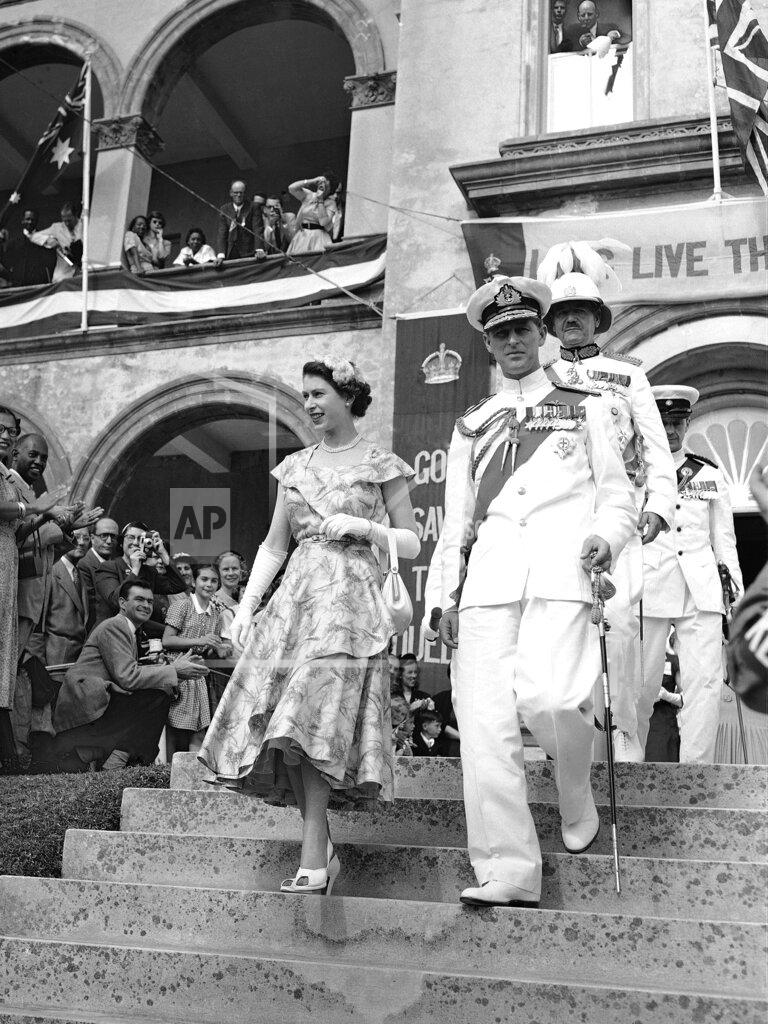 Uncredited FILE - In this file photo dated Nov. 25, 1953, Britain's Queen Elizabeth II and the Duke of Edinburgh leaving the House Of Assembly after the Queen had addressed Bermuda's Colonial Parliament, in Hamilton, Bermuda. The Governor of Bermuda Lieutenant General Sir Alexander Hood follows the Queen and Duke down the steps. Prince Philip who died Friday April 9, 2021, aged 99, lived through a tumultuous century of war and upheavals, but he helped forge a period of stability for the British monarchy under his wife, Queen Elizabeth II. Philip helped create the Commonwealth of nations, with the queen at its head, in an attempt to bind Britain and its former colonies together on a more equal footing. (AP Photo, FILE)