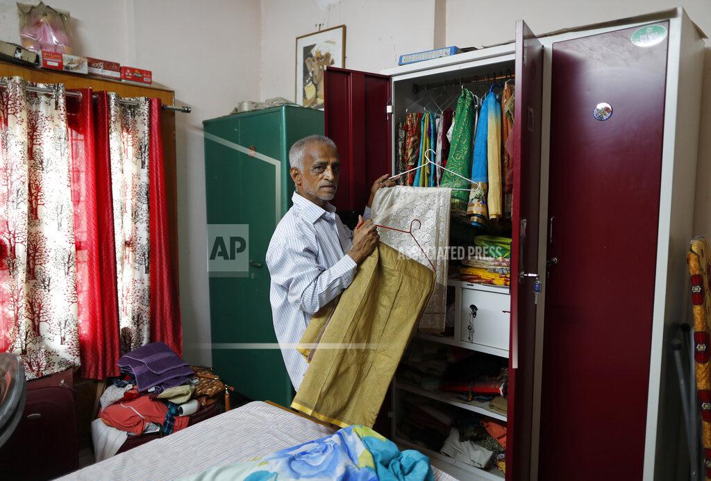 Rajesh Kumar Singh Radha Gobindo Pramanik arranges the saris of his wife, days after she died of the coronavirus, in Lucknow, India, Friday June 4, 2021. Within days, Pramanik's wife, his daughter and his unborn grandchild were among the tens of thousands killed as the coronavirus ravaged the country in April and May. As India emerges from its darkest days of the pandemic, families across the country are grieving all that they’ve lost and are left wondering if more could have been done to avoid this tragedy. (AP Photo/Rajesh Kumar Singh)