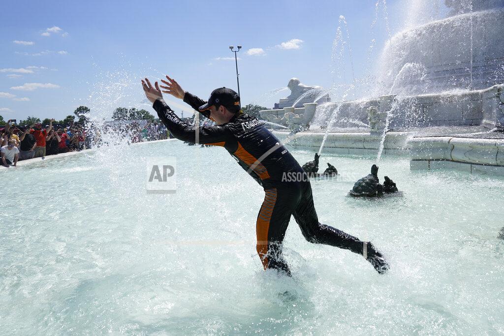 Paul Sancya Pato O'Ward celebrates by jumping into James Scott Memorial Fountain after winning the second race of the IndyCar Detroit Grand Prix auto racing doubleheader on Belle Isle in Detroit Sunday, June 13, 2021. (AP Photo/Paul Sancya)