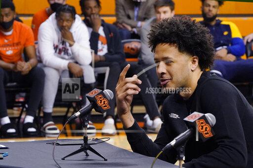 Sue Ogrocki With his teammates looking on at rear, Cade Cunningham announces that he will enter the NBA draft after a dynamic freshman season that saw him named a first-team AP All-American, Thursday, April 1, 2021, in Stillwater, Okla. (AP Photo/Sue Ogrocki)