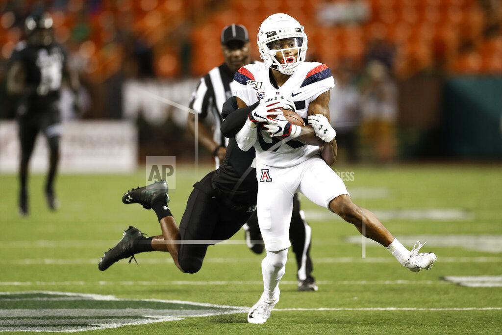 Marco Garcia Hawaii defensive back Rojesterman Farris II (4) tries to pull down Arizona wide receiver Stanley Berryhill III (86) in the second half of an NCAA college football game, Saturday, Aug. 24, 2019, in Honolulu. (AP Photo/Marco Garcia)