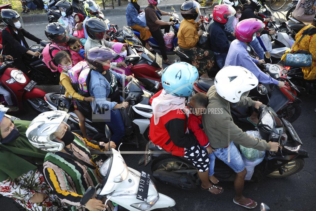 Trisnadi Motorists queue up to cross Suramadu Bridge connecting Java and Madura Island, as they head to their home villages to celebrate Eid al-Fitr holiday that marks the end of Ramadan, in Surabaya, East Java, Indonesia, Wednesday, May 12, 2021. The mass exodus out of major cities in the world's most populous Muslim country is underway despite travel prohibition imposed by the government ahead of the holiday to prevent spikes in COVID-19 cases. (AP Photo/Trisnadi)