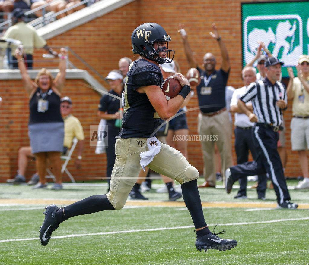 Nell Redmond Wake Forest quarterback Sam Hartman rushes for a touchdown against Towson in the first half of an NCAA college football game in Winston-Salem, N.C., Saturday, Sept. 8, 2018. (AP Photo/Nell Redmond)