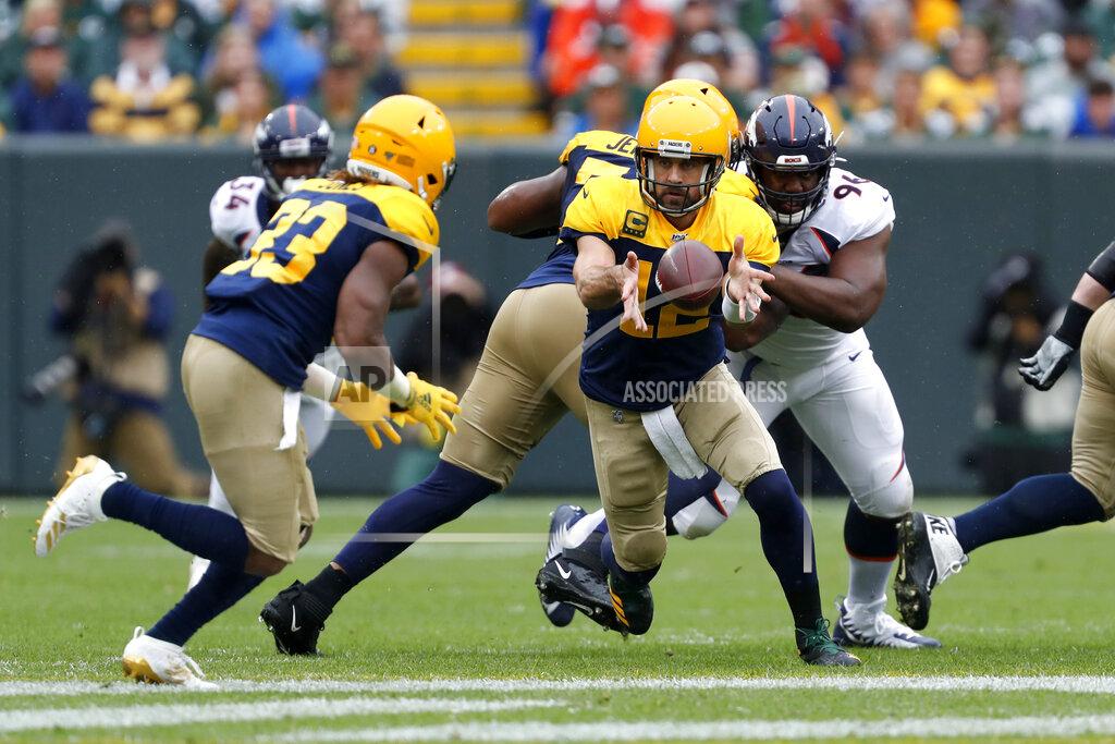 Matt Ludtke Green Bay Packers quarterback Aaron Rodgers, right, pitches the ball to running back Aaron Jones, left, during the first half of an NFL football game against the Denver Broncos Sunday, Sept. 22, 2019, in Green Bay, Wis. (AP Photo/Matt Ludtke)